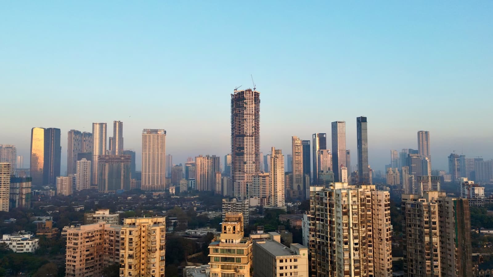 Invisible grill on an Ahmedabad high-rise balcony overlooking the city skyline